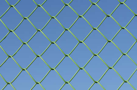 Security and texture. Against the background of the blue sky, the cellular metal mesh is green.