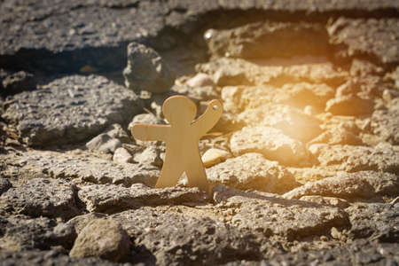 Transport movement concept. A figurine of a man draws attention to a hole in the asphalt on the road.の写真素材