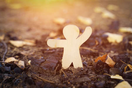 Environmental concept. The wooden figurine indicates the ashes from the fire.の写真素材