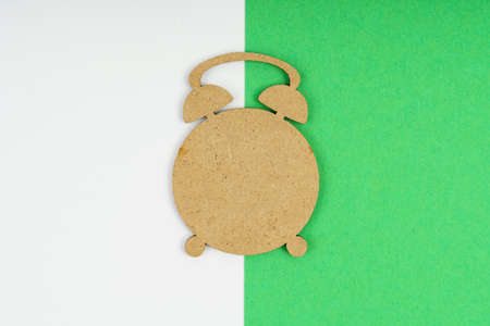 Environmental concept. Wooden clock on a white green background.の写真素材
