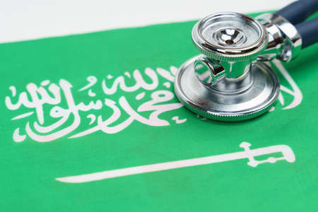 Medicine and economics concept. There is a stethoscope on the flag of Saudi Arabia.の写真素材
