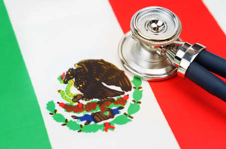 Medicine and economics concept. Stethoscope on the flag of Mexico.の写真素材