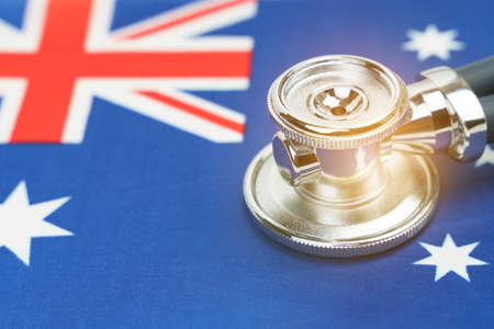 Medicine and economics concept. There is a stethoscope on the flag of Australia.の写真素材