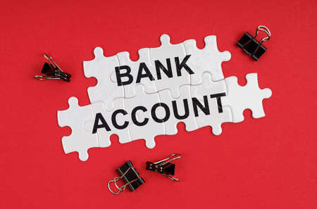 Business and Economics. On a red background, there are puzzles with the inscription - Bank Accountの写真素材