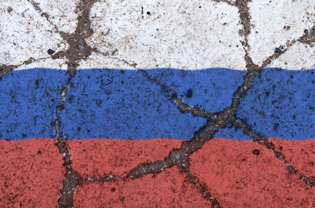 Russian flag on the cracked asphalt. The concept of crisis, default, economic collapse, pandemic, conflict, in terrorism the country. Out of focus imageの写真素材