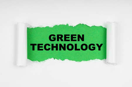 Environmental concept. In the middle of the white sheet, the paper is torn, inside on a green background the inscription - Green Technologyの写真素材