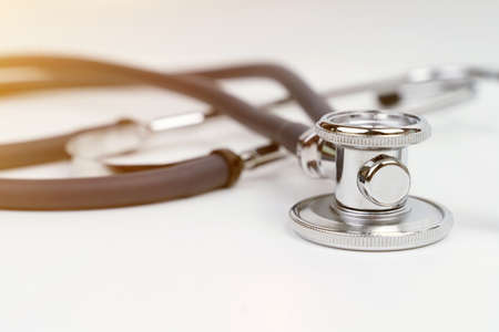 Medical equipment. On a white background stethoscope. Close-up, flare.