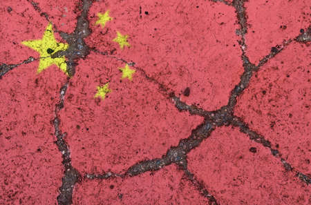 China flag on cracked asphalt. The concept of crisis, default, economic collapse, pandemic, conflict, terrorism in the country. Out of focus imageの写真素材