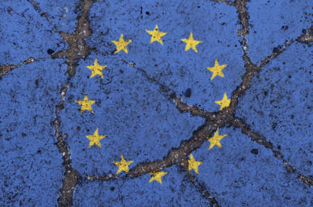 UE flag on cracked asphalt. The concept of crisis, default, economic collapse, pandemic, conflict,...