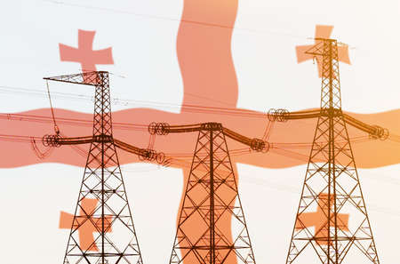 Industry and energy concept. Double exposure - power line, tower and flag Georgiaの写真素材