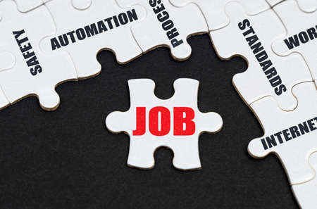Industry concept. On a black background, puzzles with inscriptions, on a separate puzzle there is an...