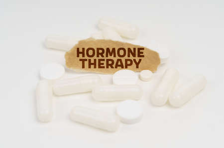 Medicine and health concept. On a white background pills and a piece of paper with the inscription - HORMONE THERAPYの写真素材