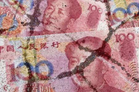 Business and finance concept. On the cracked asphalt there is an image of the Chinese yuan.の写真素材
