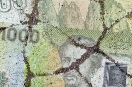 Business and finance concept. On the cracked asphalt there is a picture of the Chilean peso.