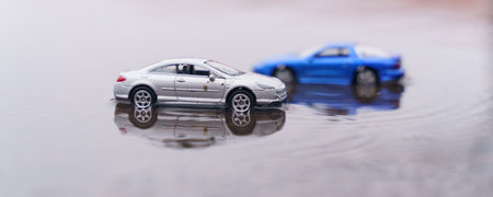 Natural disasters. Two cars are moving along the road after a heavy rain. One of them is out of focus.の写真素材