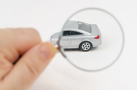 The car is being examined by a mechanic. Car service and purchase concept. Isolated on white background.の写真素材