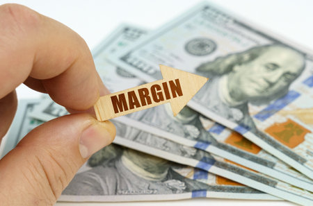 business and finance concept. In the hands of a man is an arrow with the inscription - MARGIN, in...