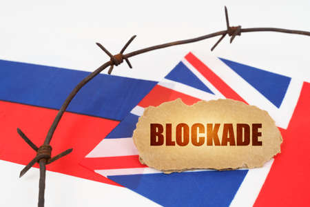 political concept. On the flags of Great Britain and Russia there is a cardboard plate with the...