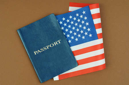 Migration concept. On a brown surface lies a passport with the US flag inside.