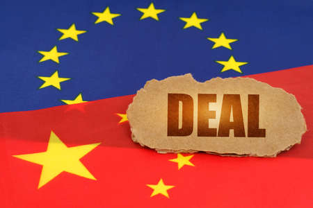 political concept. On the flags of China and the European Union lies a cardboard plate with the inscription - Dealの写真素材