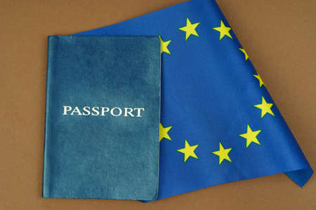 Migration concept. On a brown surface lies a passport inside which is the flag of the European Unionの写真素材