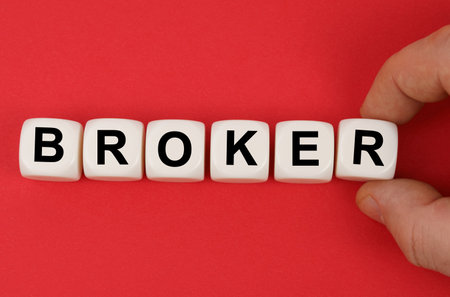 business and finance. On the red surface, white cubes with the inscription - BROKERの写真素材