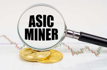 business and technology concept. On the chart with quotes are bitcoins and there is a magnifying...