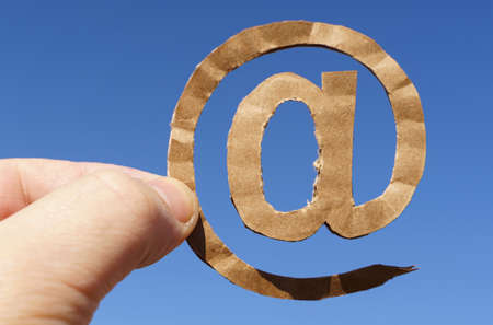 symbols. Against the background of the sky in the hands of a man the symbol of e-mail