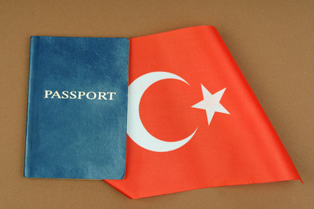 Migration concept. On a brown surface lies a passport inside which is the flag of Turkeyの写真素材