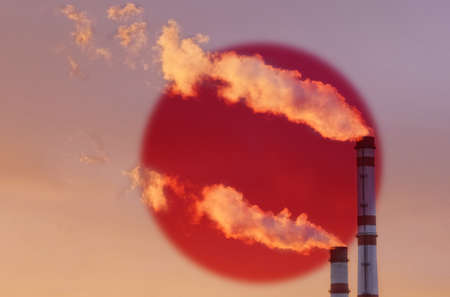 Against the background of the flag of Japan, smoke is emitted from the chimneys of the enterprise,...