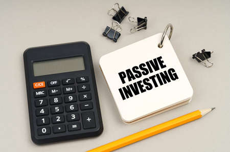business concept. On a gray surface, a calculator, a pencil and a notepad with the inscription -...