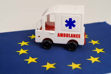 medical concept. There is a toy ambulance on the flag of the European Union.の写真素材