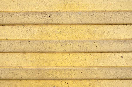 Yellow texture of poured concrete with repeating horizontal stripes. backgrounds and textures.の写真素材