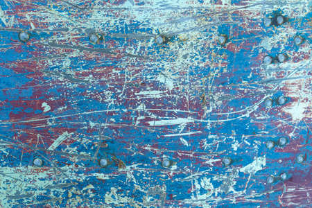 Texture of rusty metal with rivets, blue and red paints. textures and backgrounds