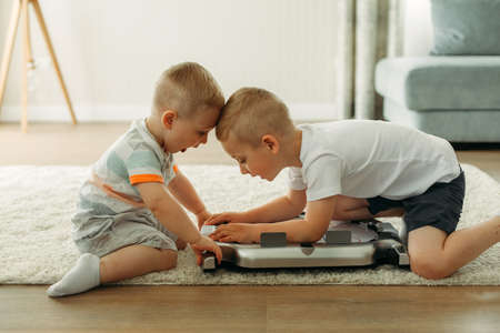 Children sit on the floor and play table hockey. children's games.の写真素材