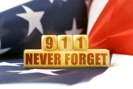 On the flag of the United States are wooden blocks and cubes with the inscription - 911 Never Forget. USA. Memorable daysの写真素材