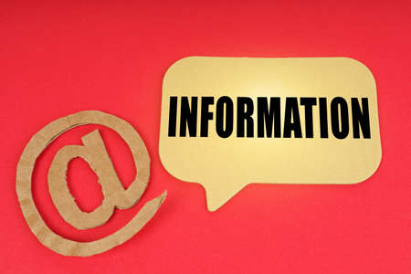 email and business. On a red surface, a symbol and a sign with the inscription - Informationの写真素材