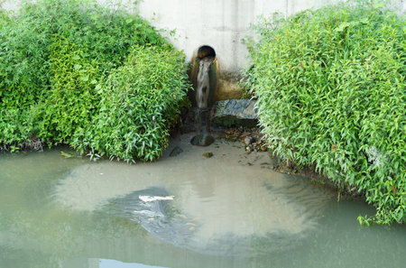 water pollution. Water contaminated with chemicals and other substances enters the river through the sewer. ecological conceptの写真素材