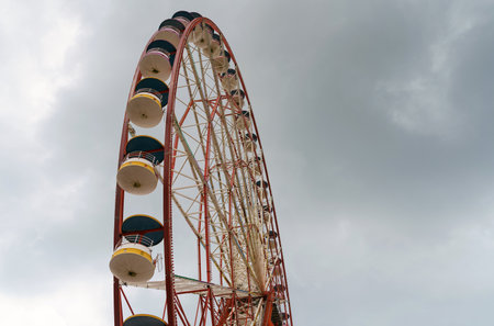 Attraction ferris wheel on the background of a stormy sky. Attractions and bad weather.の写真素材