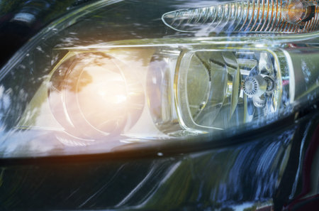 Glowing yellow headlight of a car. close-up. transport concept.