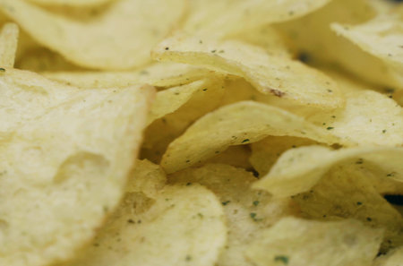Potato chips on a rotating surface. close-up. food.の写真素材