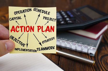 business concept. In the hands of a man is a sticker with the inscription - action plan. In the...