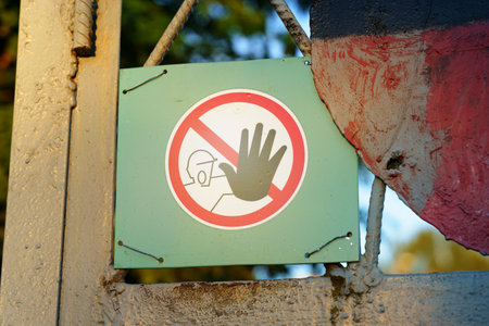 A warning sign hangs on the fence - entry into the restricted area is prohibited. close-up.の写真素材