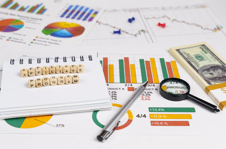business concept. On charts with economic indicators lie office items and cubes with the inscription...
