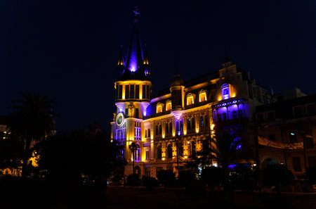 BATUMI, GEORGIA, AJARIA - AUGUST 30, 2022: Building with astronomical clock on Europe Square. Dark time of day, light on the buildingのeditorial素材