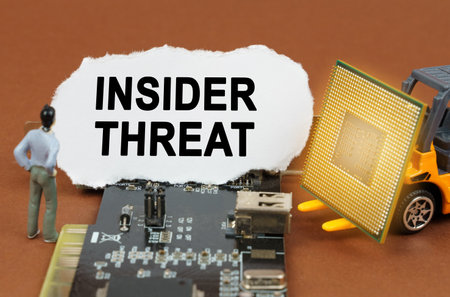 computer concept. On the board with microcircuits lies a paper plate with the inscription - Insider...