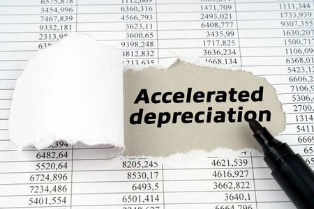 business concept. In the middle of the document with financial statements, there is a hole with the inscription - Accelerated depreciationの写真素材
