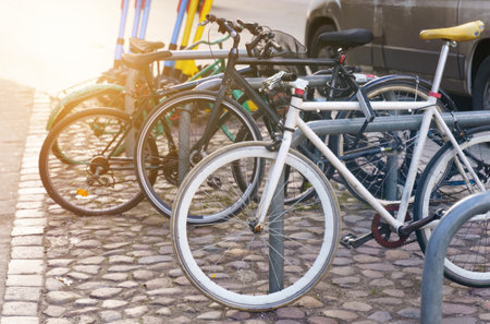 Bicycle parking in the city center on the cobblestone pavement.の写真素材