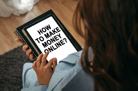 online learning concept. A woman holds a tablet in her hands on the screen of which it is written - How To Make Money Onlineの写真素材