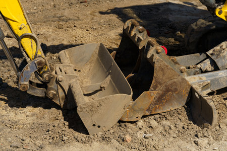 Close-up of two excavator buckets at a construction site. Construction machinery for earthworks